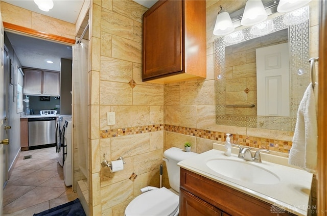 2946 Rockledge Trl, Beavercreek, OH 45430 - bathroom featuring vanity, a shower stall, tile walls, tile patterned flooring, and washer / clothes dryer