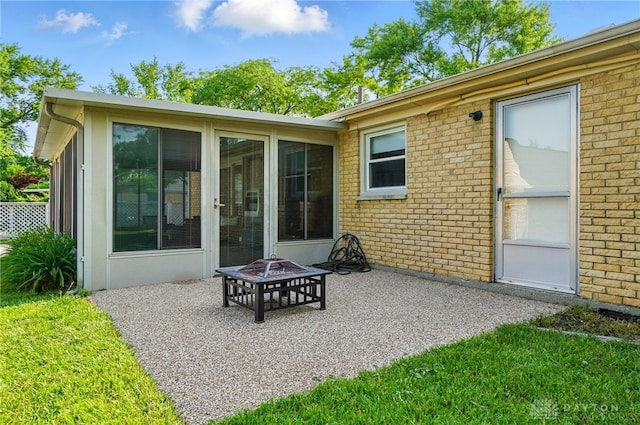 2946 Rockledge Trl, Beavercreek, OH 45430 - view of patio / terrace with a fire pit and a sunroom