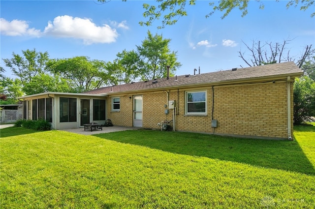 2946 Rockledge Trl, Beavercreek, OH 45430 - rear view of house featuring a sunroom, a patio, a yard, brick siding, and a fire pit