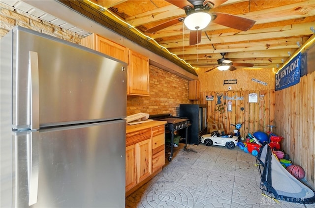 2946 Rockledge Trl, Beavercreek, OH 45430 - kitchen with freestanding refrigerator, ceiling fan, wooden walls, light brown cabinetry, and wooden counters