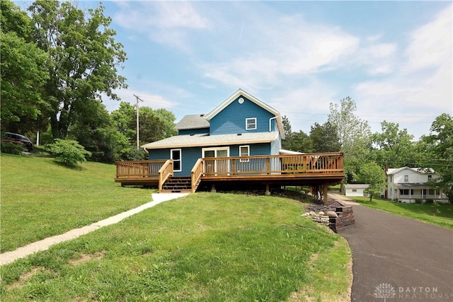 506 Linden Ave, Dayton, OH 45403 - view of front of home with a deck, a front lawn, and view of wooded area