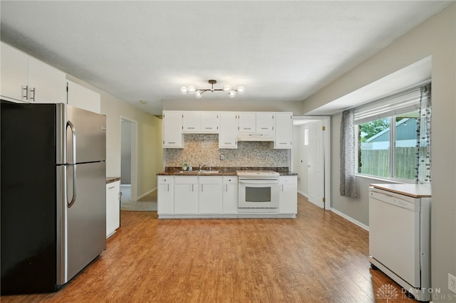 75 Royal Dr, Springboro, OH 45066 - kitchen with white appliances, light wood finished floors, white cabinets, dark countertops, and under cabinet range hood