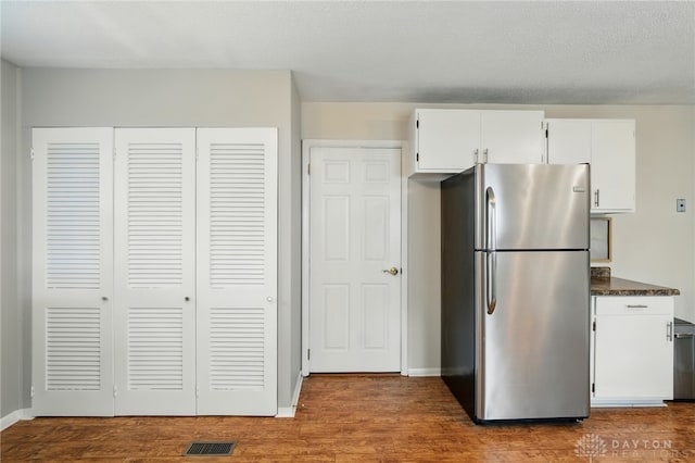 75 Royal Dr, Springboro, OH 45066 - kitchen with freestanding refrigerator, white cabinetry, and dark wood finished floors
