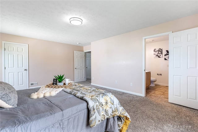 1928 Spring Ridge Dr, Xenia, OH 45385 - carpeted bedroom featuring connected bathroom and a textured ceiling
