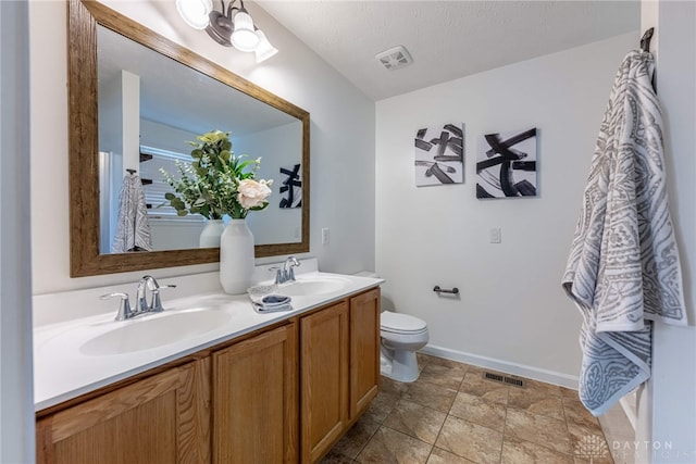 1928 Spring Ridge Dr, Xenia, OH 45385 - bathroom featuring double vanity and stone finish flooring