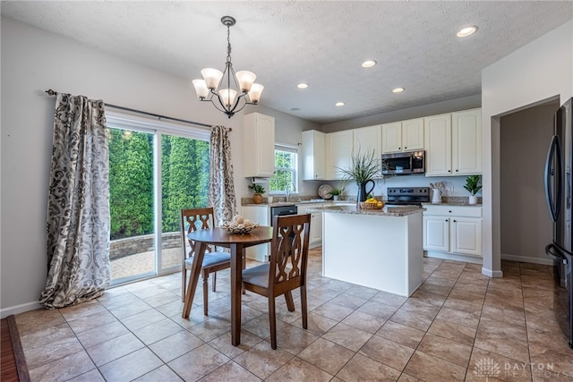1928 Spring Ridge Dr, Xenia, OH 45385 - dining space with a chandelier, recessed lighting, a textured ceiling, and light tile patterned floors