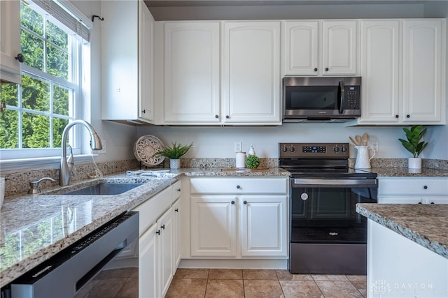 1928 Spring Ridge Dr, Xenia, OH 45385 - kitchen with appliances with stainless steel finishes, light stone counters, and white cabinetry