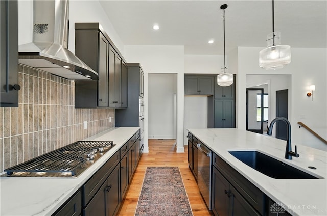 8559 Wandering Brook Way, Waynesville, OH 45068 - kitchen featuring wall chimney exhaust hood, stainless steel appliances, pendant lighting, backsplash, and light stone counters