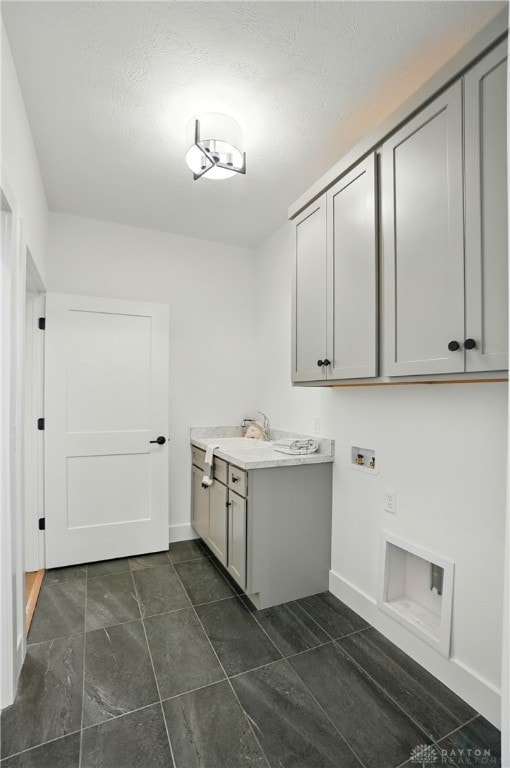 8559 Wandering Brook Way, Waynesville, OH 45068 - washroom with cabinet space, hookup for a washing machine, and a textured ceiling