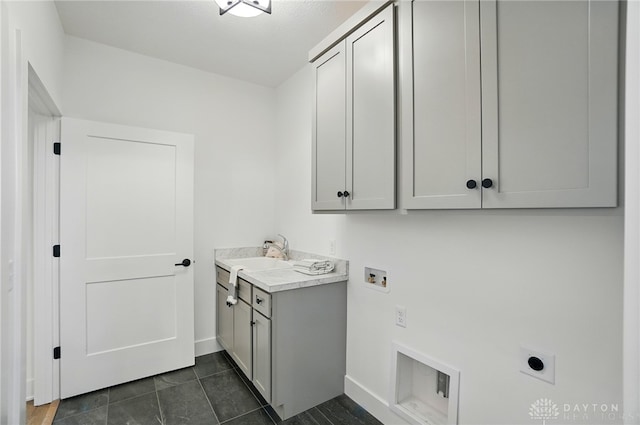 8559 Wandering Brook Way, Waynesville, OH 45068 - washroom with electric dryer hookup, cabinet space, hookup for a washing machine, and dark tile patterned floors