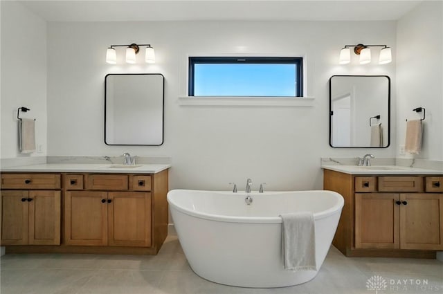 8559 Wandering Brook Way, Waynesville, OH 45068 - bathroom with two vanities, a freestanding bath, and tile patterned floors