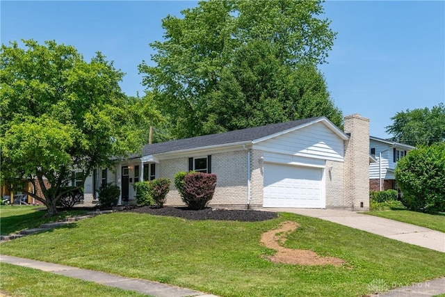390 Washington Ave, Wilmington, OH 45177 - view of front of home with an attached garage, a front yard, brick siding, and concrete driveway