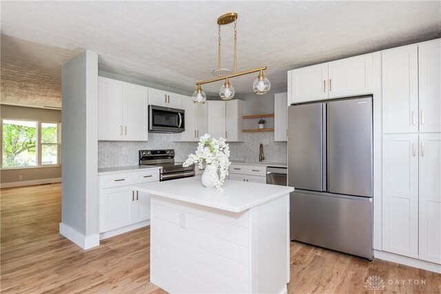 390 Washington Ave, Wilmington, OH 45177 - kitchen featuring stainless steel appliances, open shelves, and white cabinets