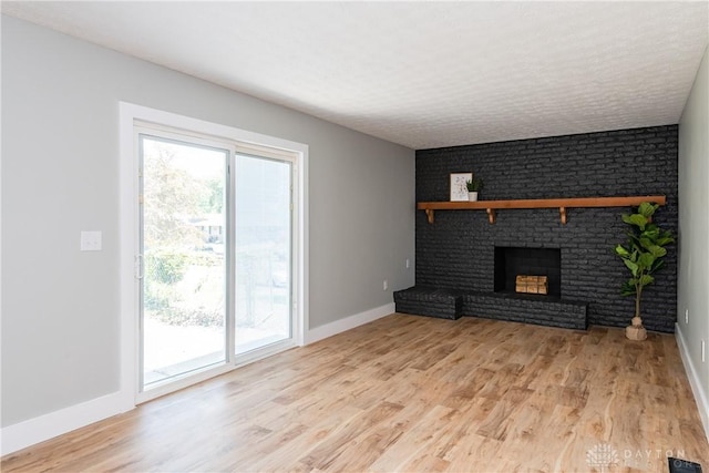 390 Washington Ave, Wilmington, OH 45177 - unfurnished living room featuring light wood-type flooring and a fireplace