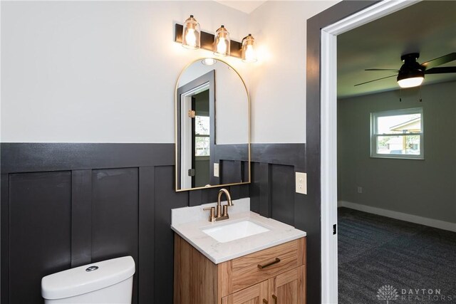 390 Washington Ave, Wilmington, OH 45177 - half bathroom with vanity, a ceiling fan, and a wainscoted wall