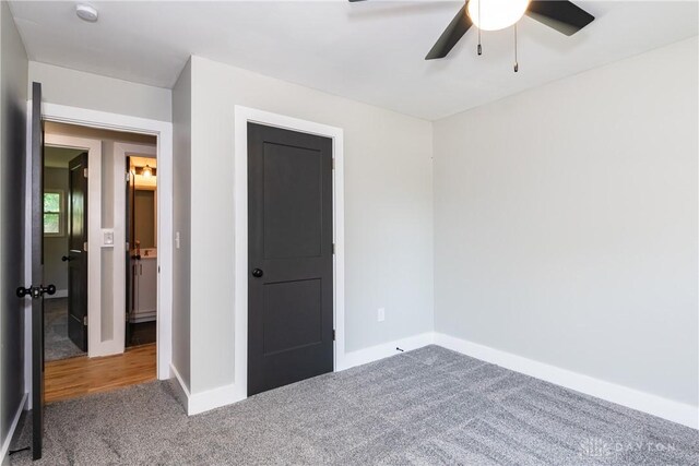 390 Washington Ave, Wilmington, OH 45177 - unfurnished bedroom featuring carpet flooring and a ceiling fan