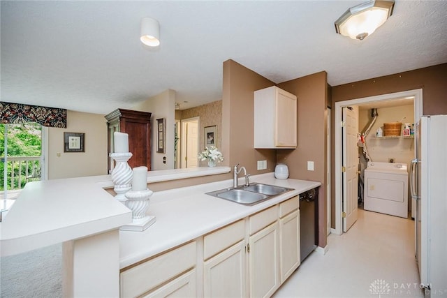 7636 Shawnee Ln Unit 206, West Chester, OH 45069 - kitchen with washer / dryer, dishwashing machine, freestanding refrigerator, a peninsula, and light countertops