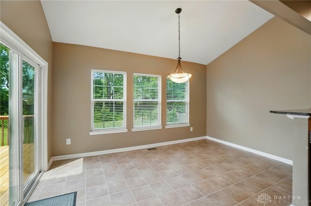1956 Daffodil Dr, Xenia, OH 45385 - unfurnished dining area with vaulted ceiling, healthy amount of natural light, and light tile patterned flooring