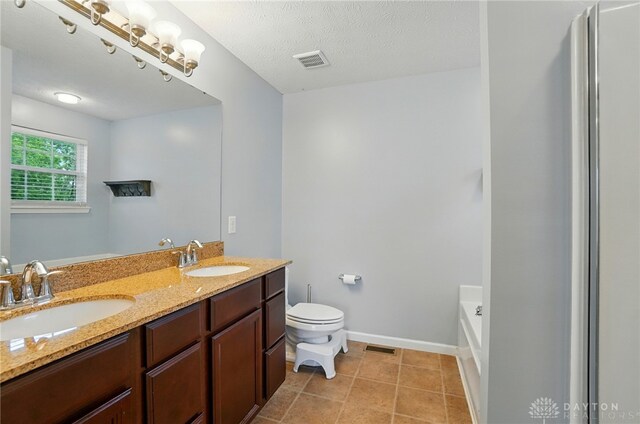 1956 Daffodil Dr, Xenia, OH 45385 - full bath with double vanity, a tub, and tile patterned floors