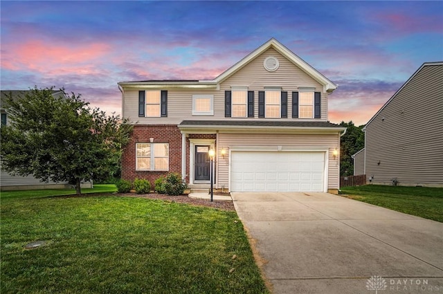1956 Daffodil Dr, Xenia, OH 45385 - traditional-style house with a garage, a lawn, and driveway