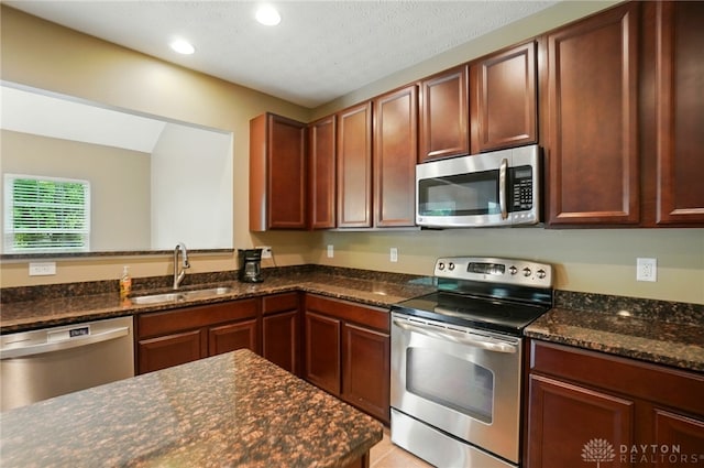 1956 Daffodil Dr, Xenia, OH 45385 - kitchen with stainless steel appliances, dark stone countertops, and recessed lighting