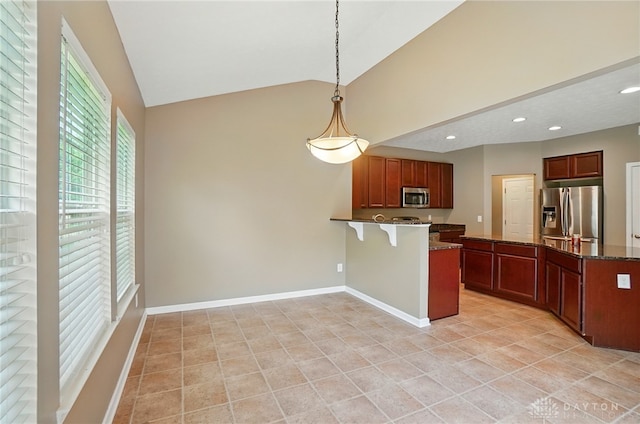 1956 Daffodil Dr, Xenia, OH 45385 - kitchen featuring stainless steel appliances, a peninsula, high vaulted ceiling, a kitchen bar, and pendant lighting