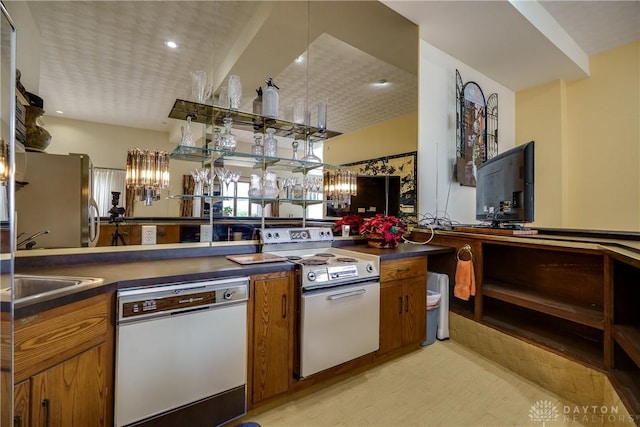 1952 Tait Circle Rd, Dayton, OH 45429 - kitchen featuring white appliances, brown cabinetry, dark countertops, and recessed lighting