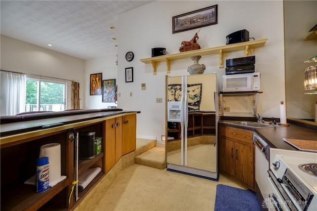 1952 Tait Circle Rd, Dayton, OH 45429 - kitchen featuring white appliances, open shelves, brown cabinets, and dark countertops