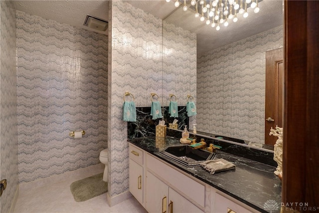 1952 Tait Circle Rd, Dayton, OH 45429 - bathroom with vanity, a textured ceiling, wallpapered walls, and tile patterned floors