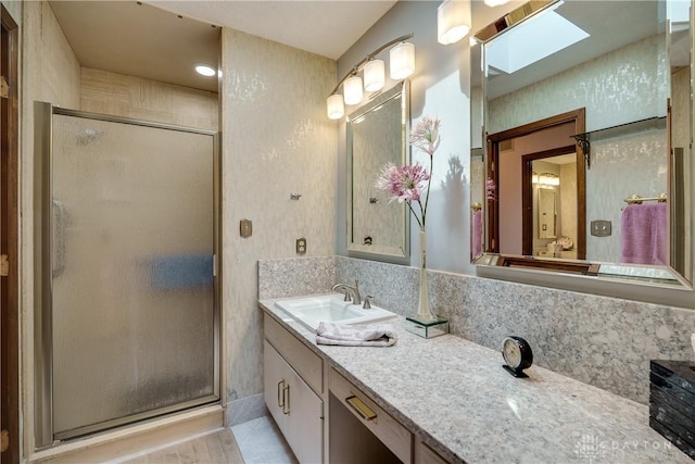 1952 Tait Circle Rd, Dayton, OH 45429 - full bathroom featuring a skylight, a stall shower, vanity, and tile patterned flooring