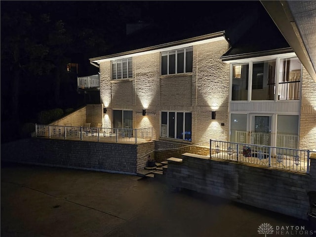 1952 Tait Circle Rd, Dayton, OH 45429 - back of house at night featuring brick siding