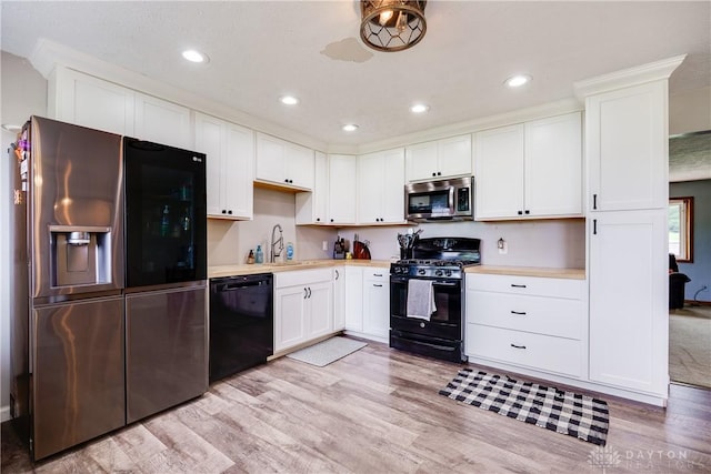 1864 E Lytle 5 Points Rd Unit R, Centerville, OH 45458 - kitchen featuring black appliances, light countertops, light wood-type flooring, white cabinetry, and recessed lighting