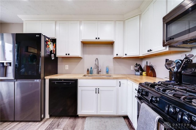 1864 E Lytle 5 Points Rd Unit R, Centerville, OH 45458 - kitchen with black appliances, light countertops, light wood-type flooring, and white cabinets