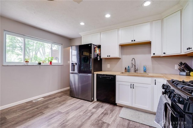 1864 E Lytle 5 Points Rd Unit R, Centerville, OH 45458 - kitchen with black appliances, light countertops, recessed lighting, light wood finished floors, and white cabinetry