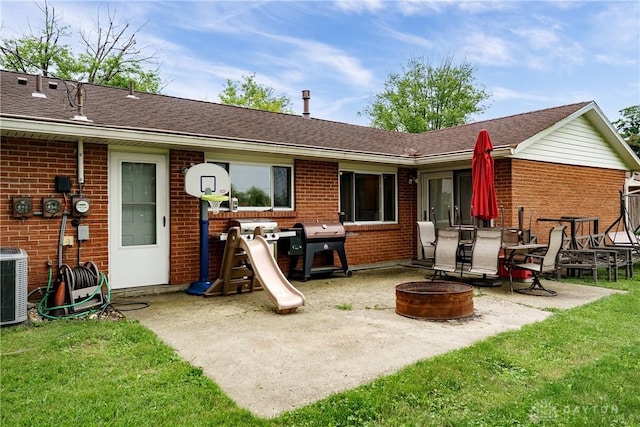 1864 E Lytle 5 Points Rd Unit R, Centerville, OH 45458 - rear view of house featuring a fire pit, brick siding, a patio, and a yard