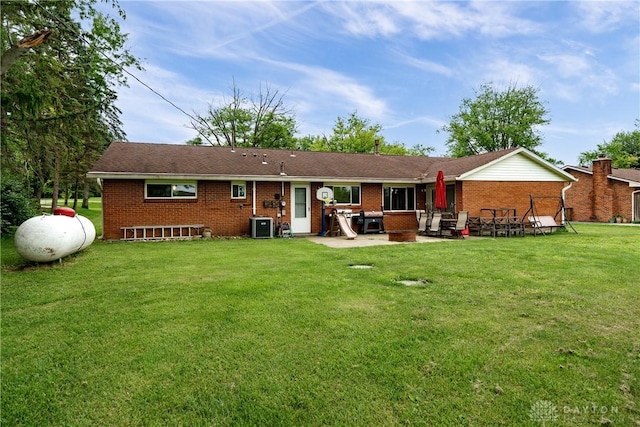 1864 E Lytle 5 Points Rd Unit R, Centerville, OH 45458 - rear view of house featuring brick siding, a patio area, and a yard