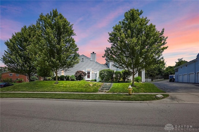 3127 Gracemore Ave, Kettering, OH 45420 - obstructed view of property featuring a lawn, stairs, and a chimney