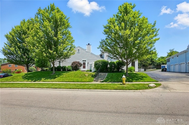 3127 Gracemore Ave, Kettering, OH 45420 - view of property hidden behind natural elements with a front lawn and a chimney