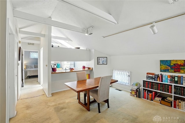 3127 Gracemore Ave, Kettering, OH 45420 - dining space featuring lofted ceiling, light colored carpet, and track lighting