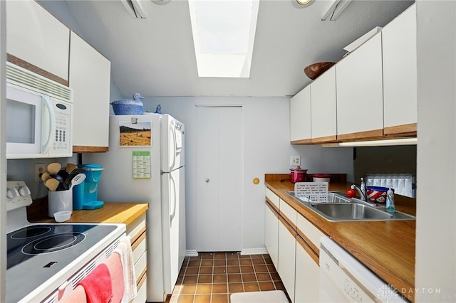 3127 Gracemore Ave, Kettering, OH 45420 - kitchen with white appliances, a skylight, white cabinets, and light countertops