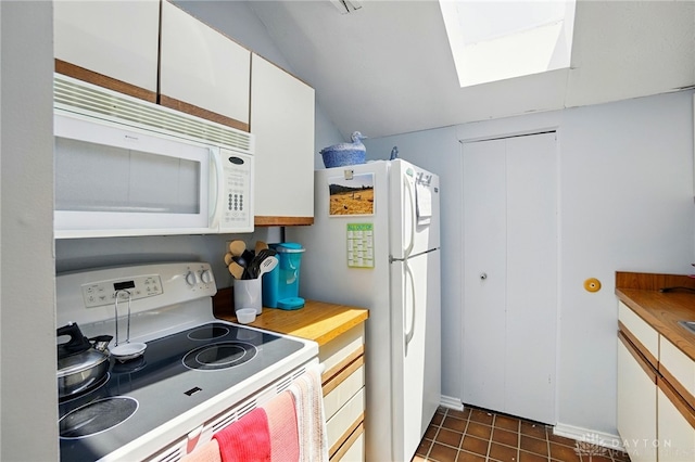 3127 Gracemore Ave, Kettering, OH 45420 - kitchen featuring white appliances, a skylight, white cabinetry, dark tile patterned flooring, and lofted ceiling
