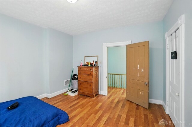 57 S Torrence St, Dayton, OH 45403 - bedroom with light wood-type flooring and a textured ceiling
