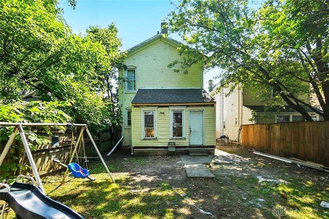 57 S Torrence St, Dayton, OH 45403 - rear view of property with a playground, entry steps, and a fenced backyard