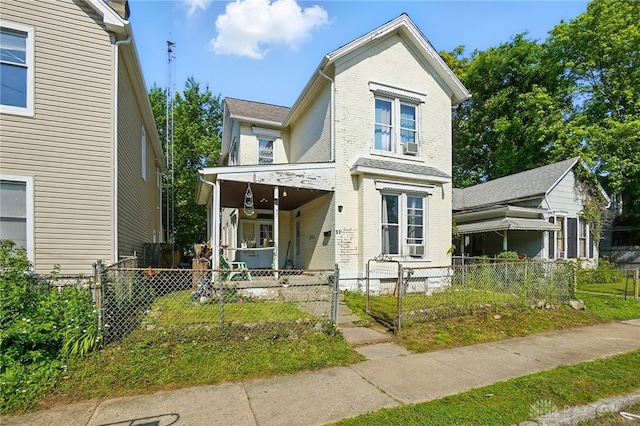 57 S Torrence St, Dayton, OH 45403 - view of front of house with covered porch, a gate, brick siding, and a fenced front yard