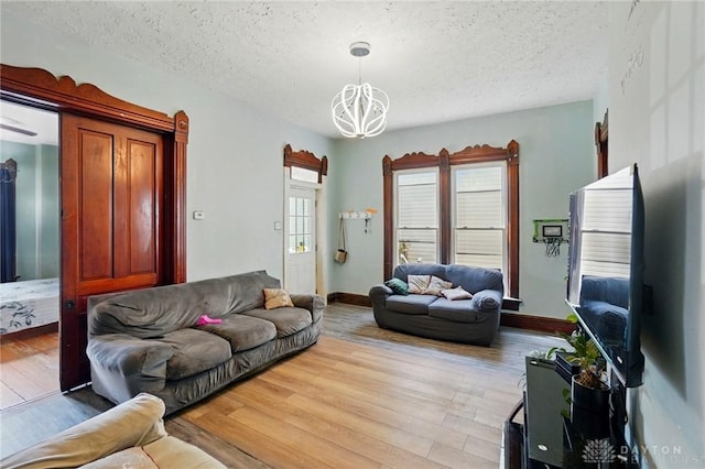 57 S Torrence St, Dayton, OH 45403 - living area featuring a chandelier, a textured ceiling, and wood finished floors