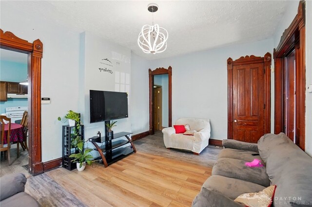 57 S Torrence St, Dayton, OH 45403 - living room featuring a chandelier, light wood-style flooring, and a textured ceiling