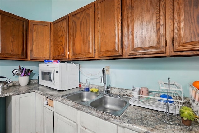 57 S Torrence St, Dayton, OH 45403 - kitchen with white microwave, brown cabinets, and light countertops