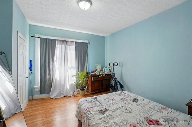 57 S Torrence St, Dayton, OH 45403 - bedroom with wood finished floors and a textured ceiling