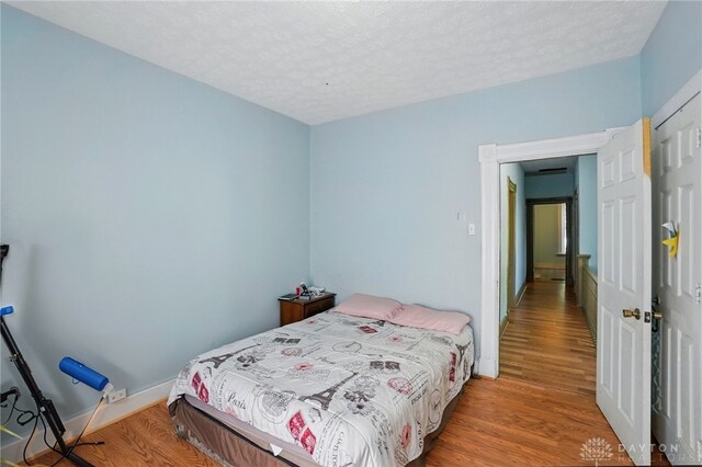 57 S Torrence St, Dayton, OH 45403 - bedroom featuring wood finished floors and a textured ceiling