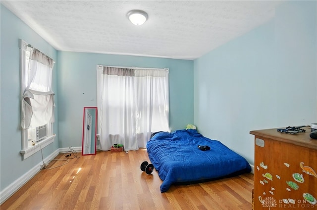 57 S Torrence St, Dayton, OH 45403 - bedroom with multiple windows, wood finished floors, a textured ceiling, and cooling unit